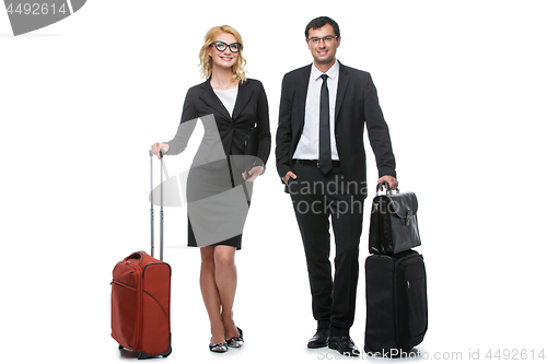 Image of Businessman and business woman with travel cases