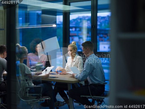 Image of Multiethnic startup business team in night office