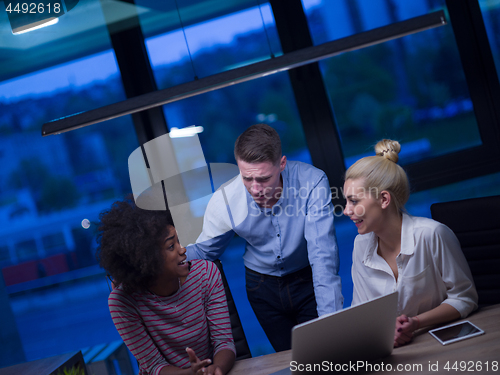 Image of Multiethnic startup business team in night office