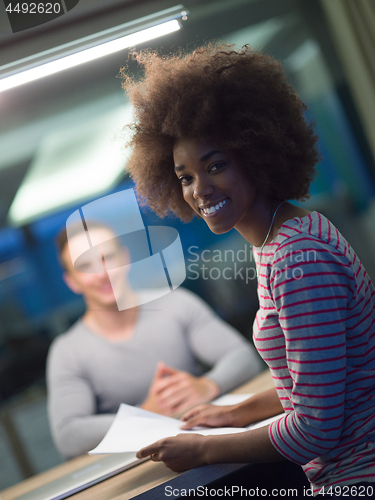 Image of Multiethnic startup business team in night office