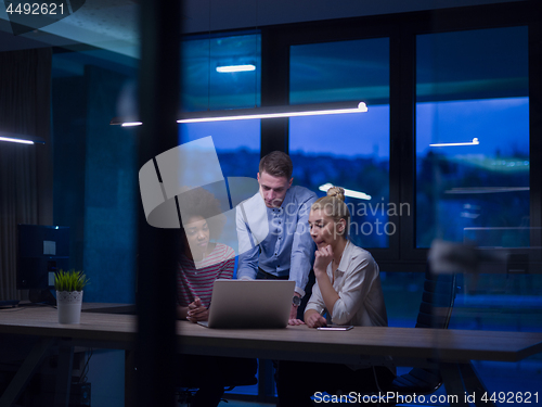 Image of Multiethnic startup business team in night office