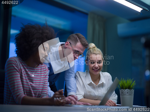 Image of Multiethnic startup business team in night office