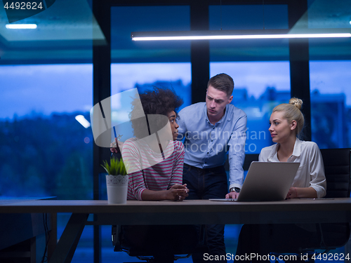 Image of Multiethnic startup business team in night office