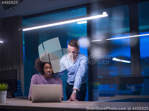 Image of Multiethnic startup business team in night office