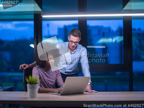 Image of Multiethnic startup business team in night office