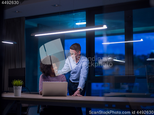 Image of Multiethnic startup business team in night office