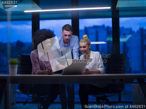 Image of Multiethnic startup business team in night office