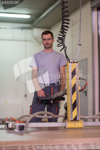 Image of worker in a factory of wooden furniture