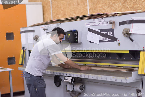 Image of worker in a factory of wooden furniture