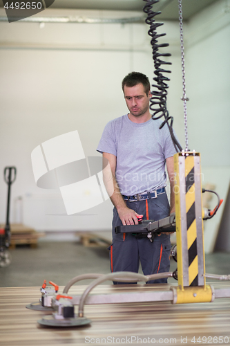 Image of worker in a factory of wooden furniture