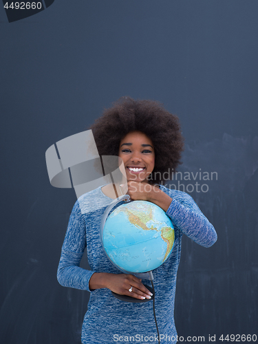 Image of black woman holding Globe of the world