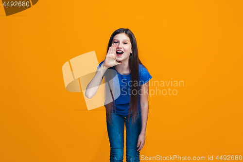 Image of Isolated on yellow young casual teen girl shouting at studio