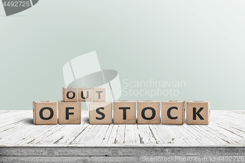 Image of Out of stock sign standing on a wooden table