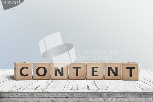 Image of Content sign made of wood on an old table