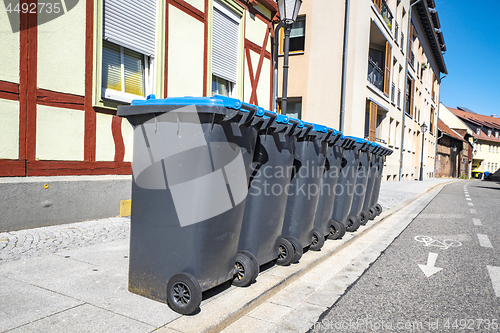 Image of Eight garbage cans on the street