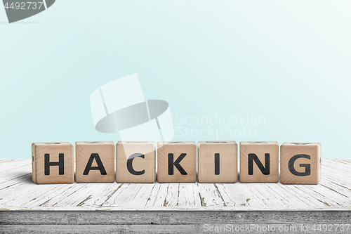 Image of Hacking sign on a wooden table