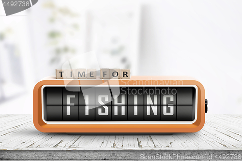 Image of Retro alarm clock with the word fishing