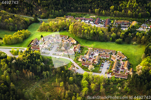 Image of Small village seen from above surrounded by forest