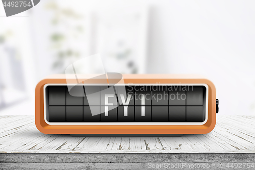 Image of FYI message on an orange alarm clock