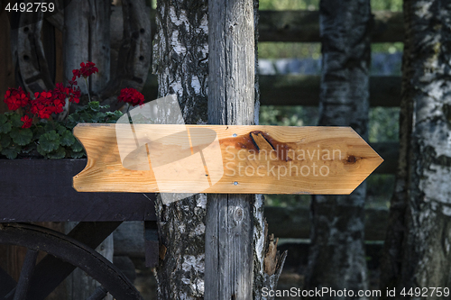 Image of Wooden arrow sign outside a house