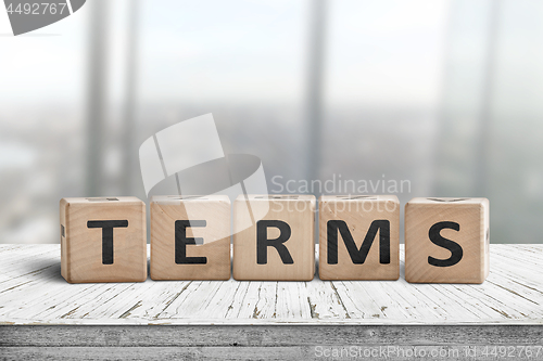 Image of Terms sign in a bright office on a wooden desk