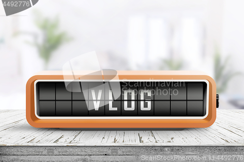 Image of Vlog word written on a retro device in orange color