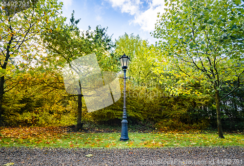 Image of Autumn scenery with a retro street lamp in a park