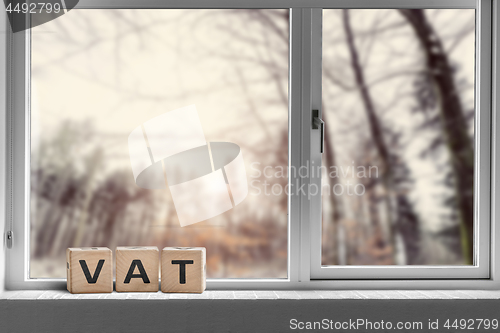 Image of VAT sign on a window sill in the morning sunrise