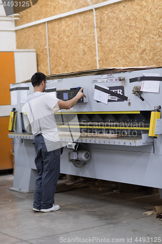 Image of worker in a factory of wooden furniture