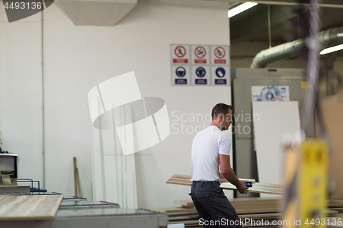 Image of worker in a factory of wooden furniture