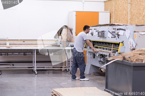 Image of worker in a factory of wooden furniture