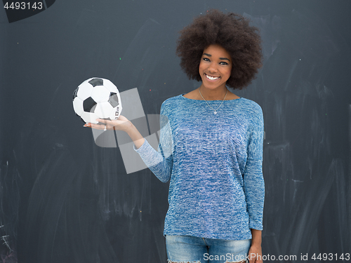 Image of black woman holding a soccer bal