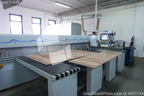 Image of worker in a factory of wooden furniture