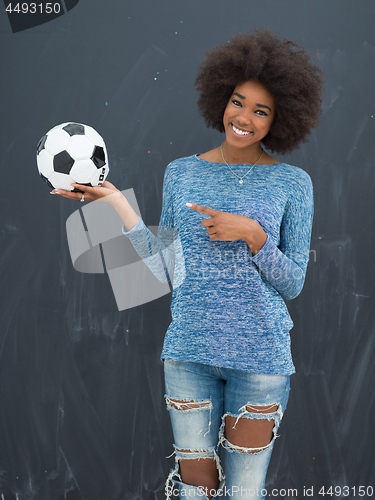 Image of black woman holding a soccer bal