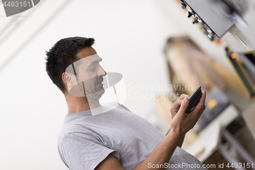 Image of worker in a factory of wooden furniture