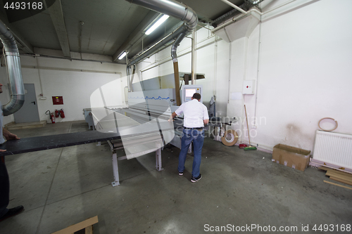 Image of workers in a factory of wooden furniture