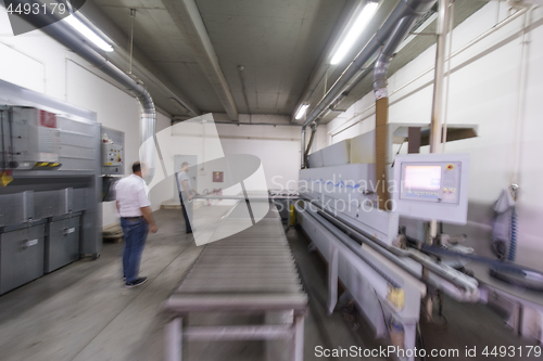 Image of workers in a factory of wooden furniture