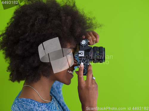 Image of black girl taking photo on a retro camera