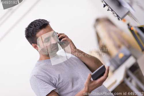 Image of engineer in front of wood cutting machine