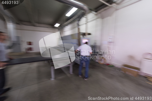 Image of workers in a factory of wooden furniture