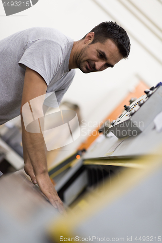 Image of worker in a factory of wooden furniture