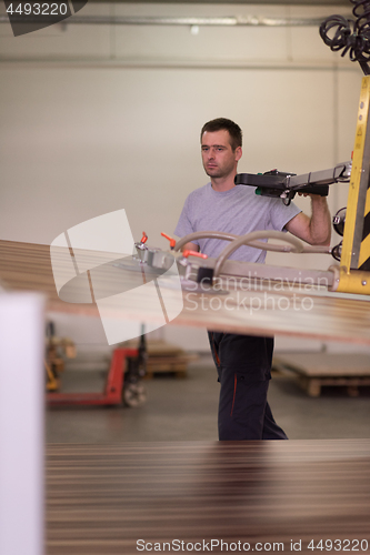 Image of worker in a factory of wooden furniture