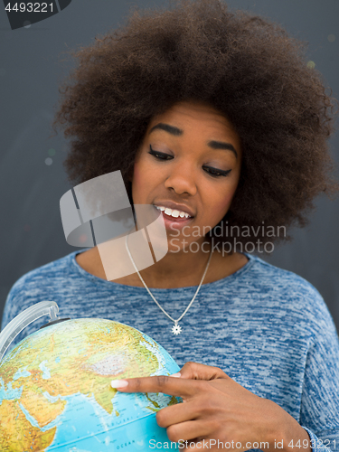 Image of black woman holding Globe of the world