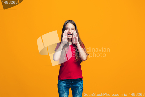 Image of Isolated on yellow young casual teen girl shouting at studio