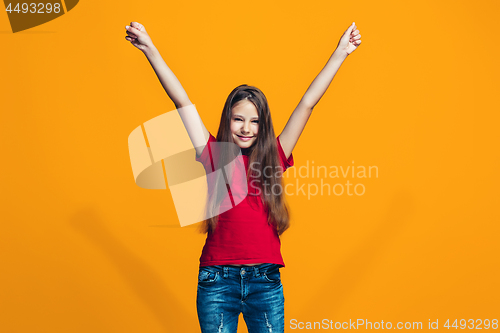 Image of Happy success teen girl celebrating being a winner. Dynamic energetic image of female model