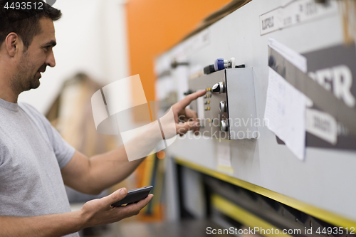 Image of worker in a factory of wooden furniture