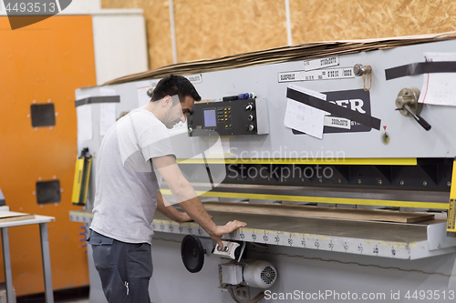 Image of worker in a factory of wooden furniture