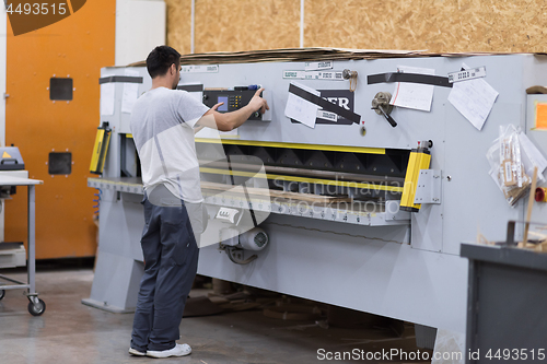 Image of worker in a factory of wooden furniture