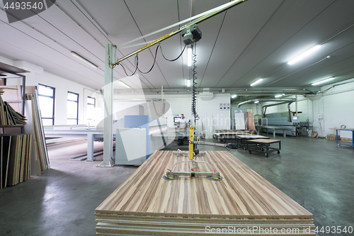 Image of worker in a factory of wooden furniture