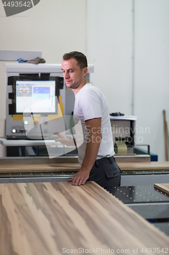 Image of worker in a factory of wooden furniture